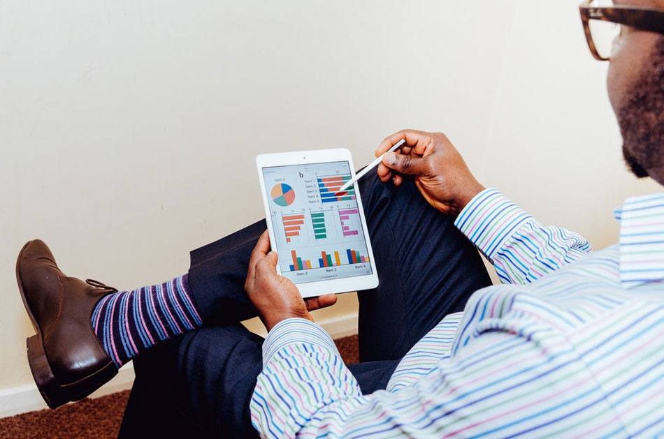 man holding tablet to view google analytics